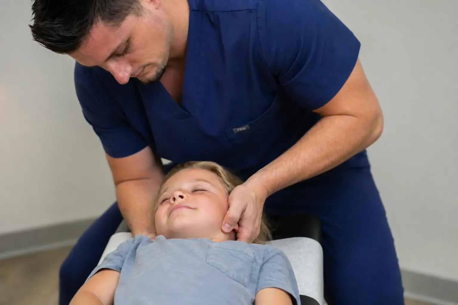 Dr. Palmer performing a gentle pediatric chiropractic adjustment in Gallatin TN